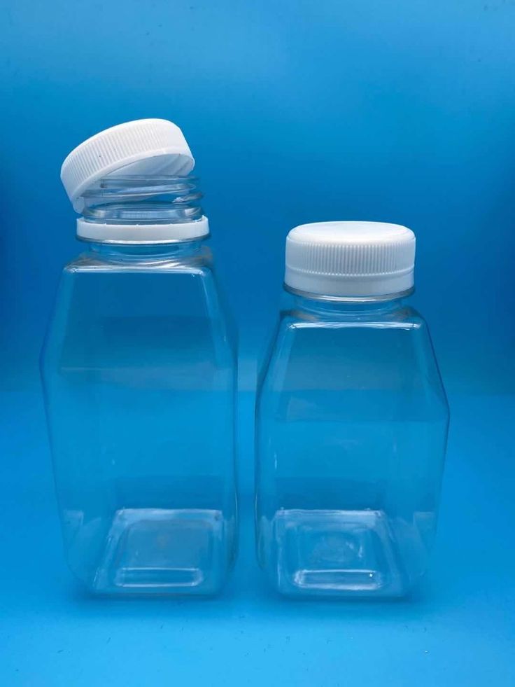 two plastic bottles with white lids on a blue background