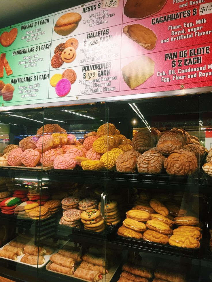 a display case filled with lots of different types of doughnuts and pastries