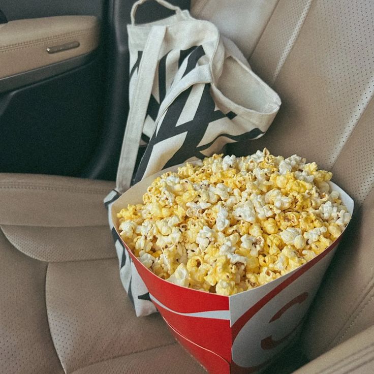 a bag of popcorn sitting in the back seat of a car