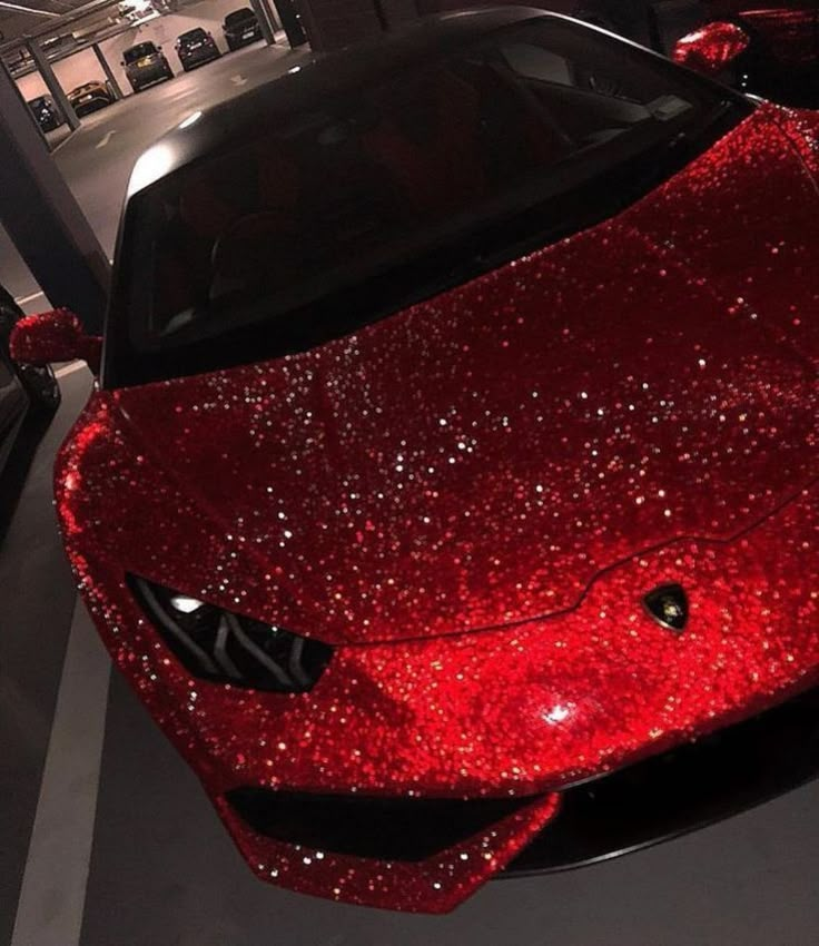 a red sports car covered in sequins on display