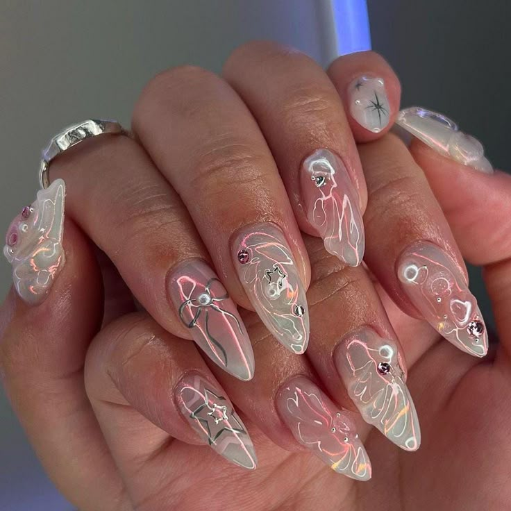 a woman's hand with some white and pink nail art