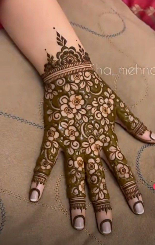 a woman's hand with henna on it