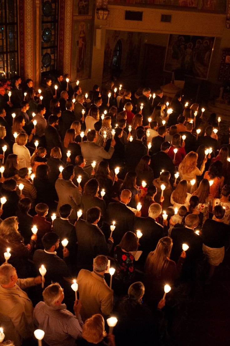 An overhead shot of a full, dark church with the lights off, only lit bye the flames of hundreds holding lit candles in front of their faces. People Holding Candles, Orthodox Wedding Candles, Vigil Candles, Easter Vigil, St Barbara, Greek Orthodox Christian, Orthodox Candles, Syriac Orthodox Church, Church Home