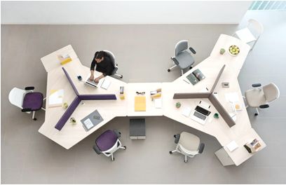 an overhead view of a table with chairs and laptops