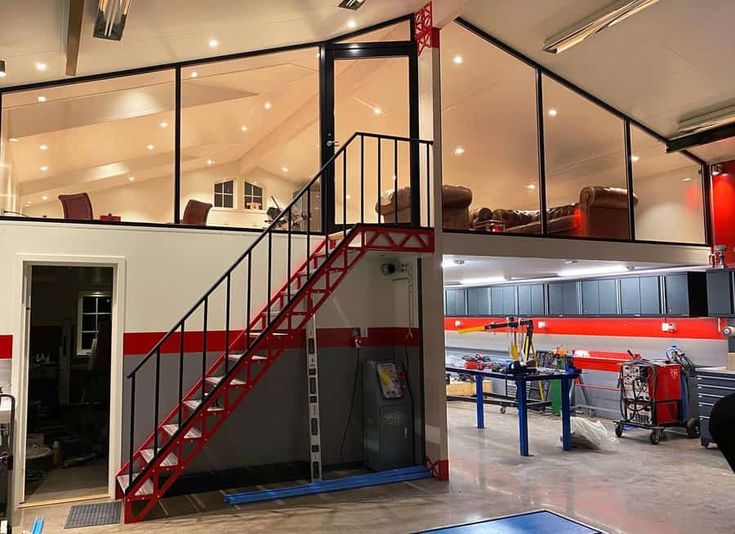 the inside of a building with stairs leading up to an open door and storage area