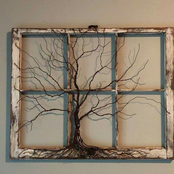 an old window frame with a tree in the middle and four panes on each side