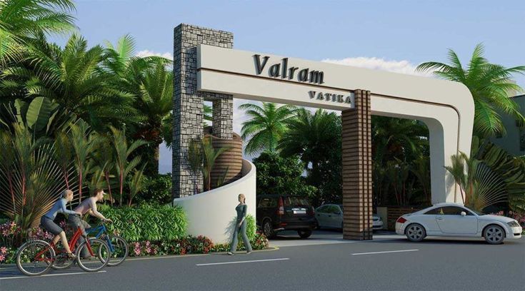 two people riding bikes in front of a very large entrance to a hotel with palm trees