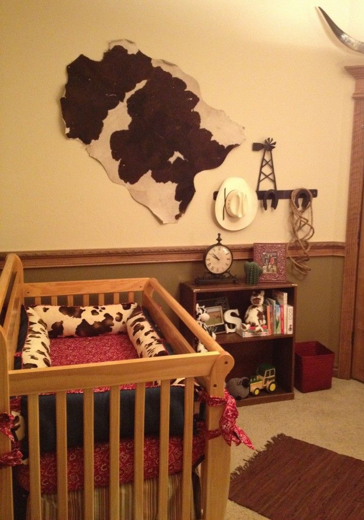 a baby's room with a crib, bookshelf and clock on the wall