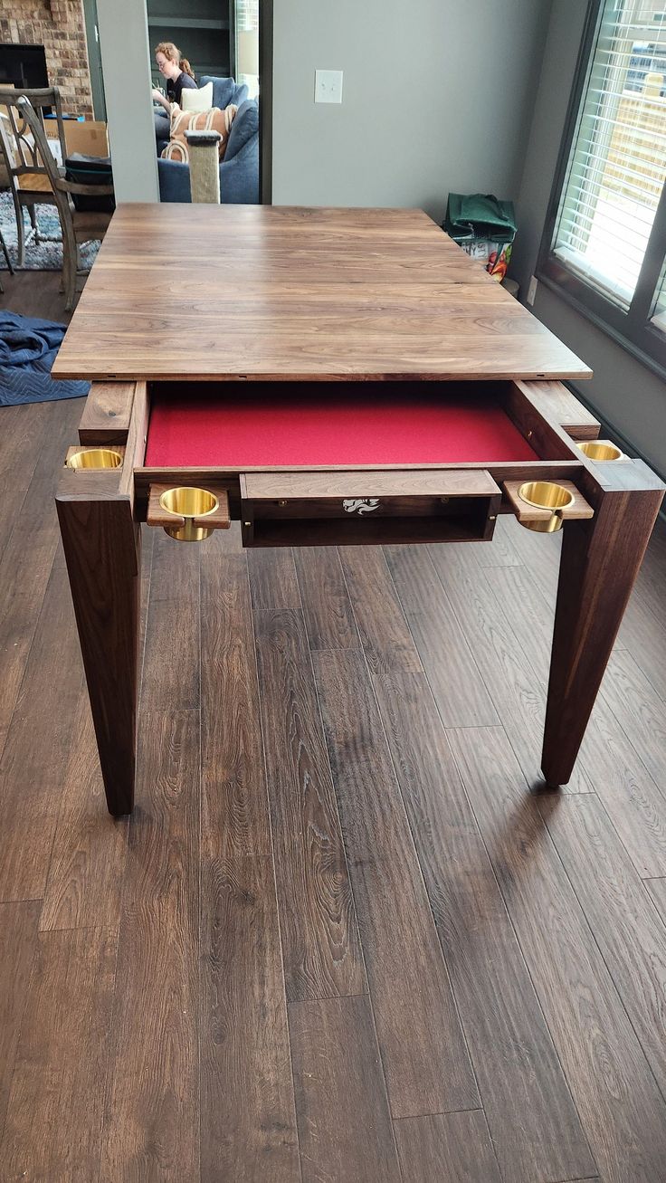 a wooden table with red cloth under it