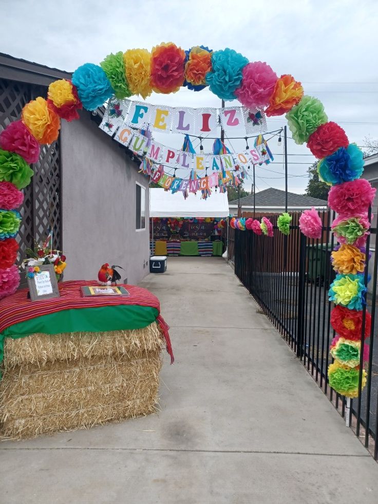 a birthday party with decorations on the fence