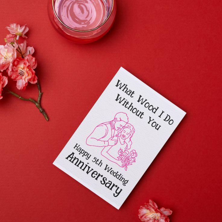 a card that says what wood i do without you is next to some pink flowers