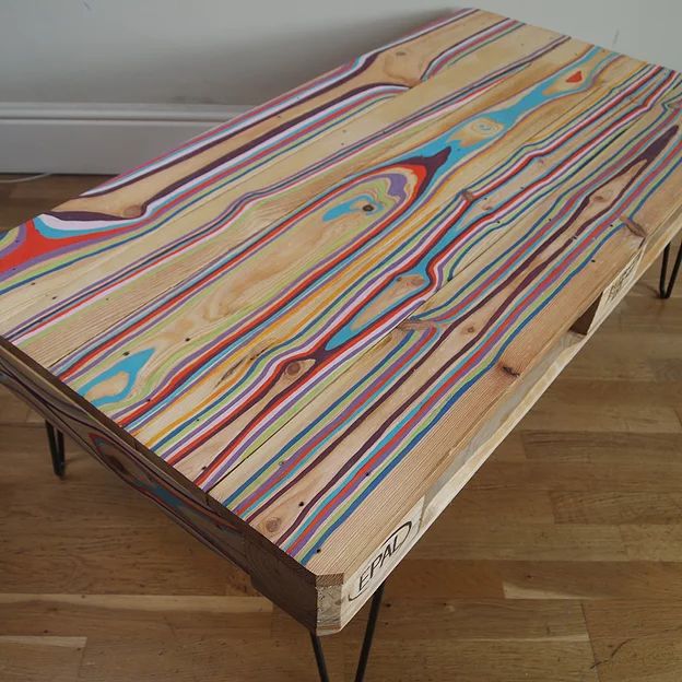 a wooden table with multicolored lines on it