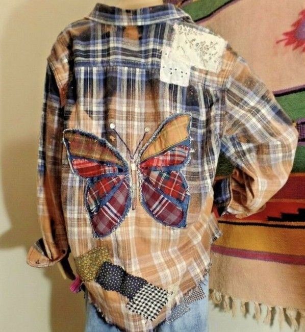 a child's plaid shirt with butterfly applique on it