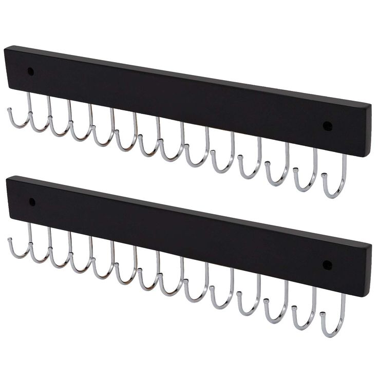 two black metal wall mounted hooks with clips on each side and one hanging from the back