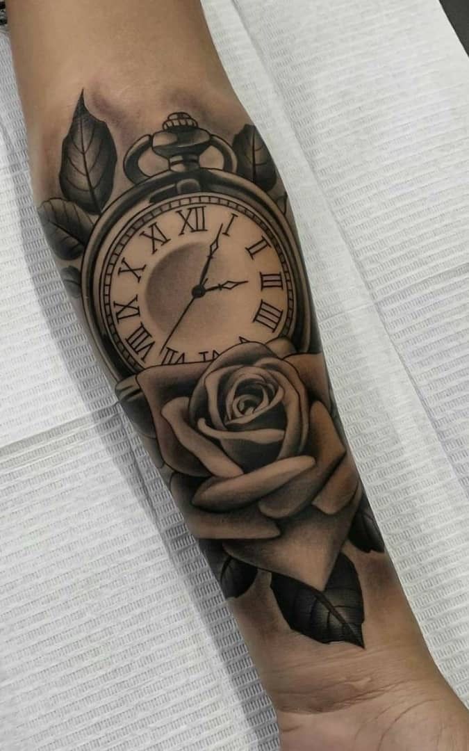 a black and white tattoo with a clock on the arm that has a rose in it