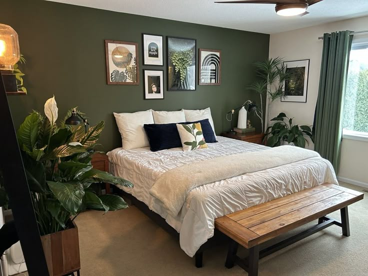 a bedroom with green walls and white bedding