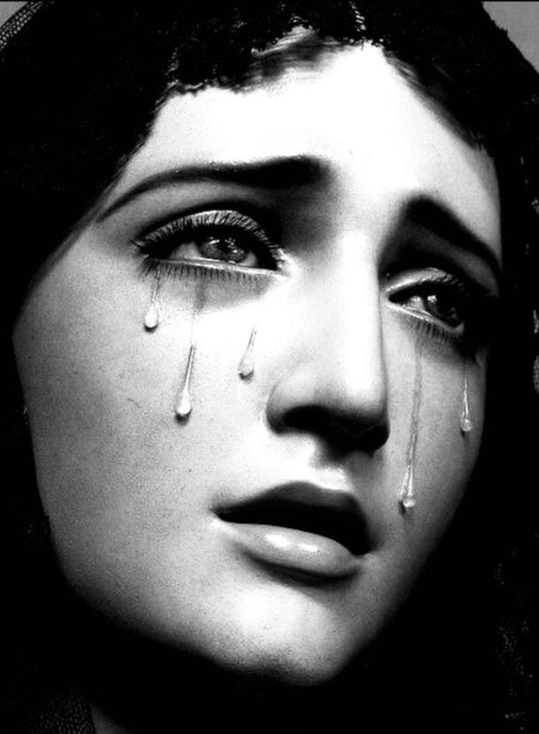 a black and white photo of a woman with tears on her face