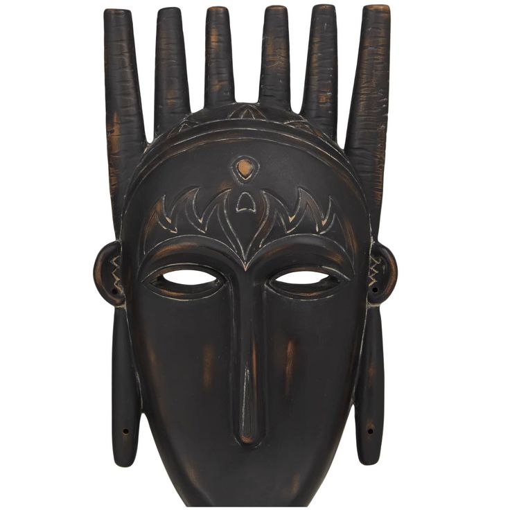 an african mask with horns on it's head and two hands in the shape of a face