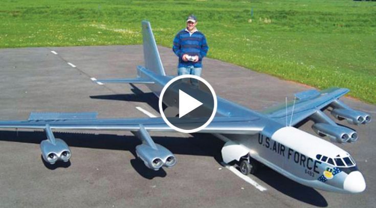 a man standing next to a model airplane