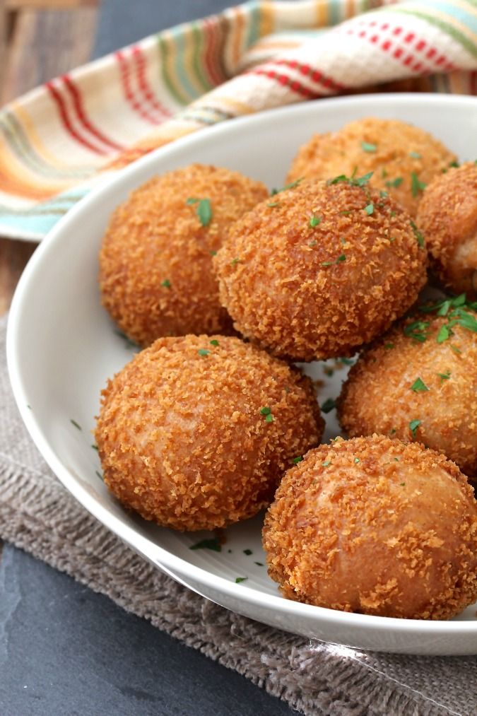 a white bowl filled with fried food on top of a table