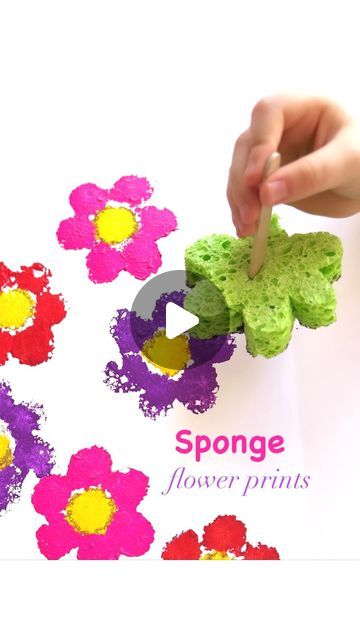 someone is painting flowers with colored crayons on the paper and writing sponge flower prints