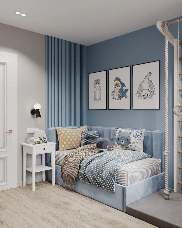 a bedroom decorated in blue and white with two pictures on the wall above the bed