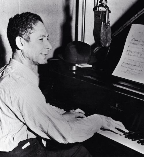 a man sitting at a piano playing music