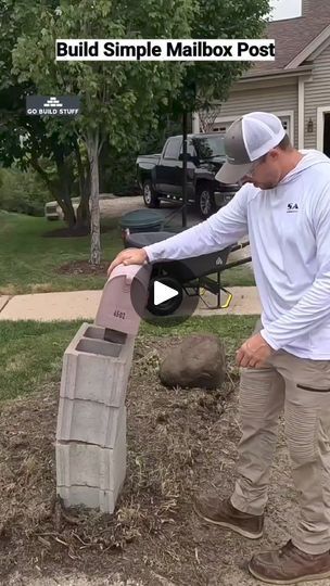 a man is placing a mailbox in the ground to put it into a box