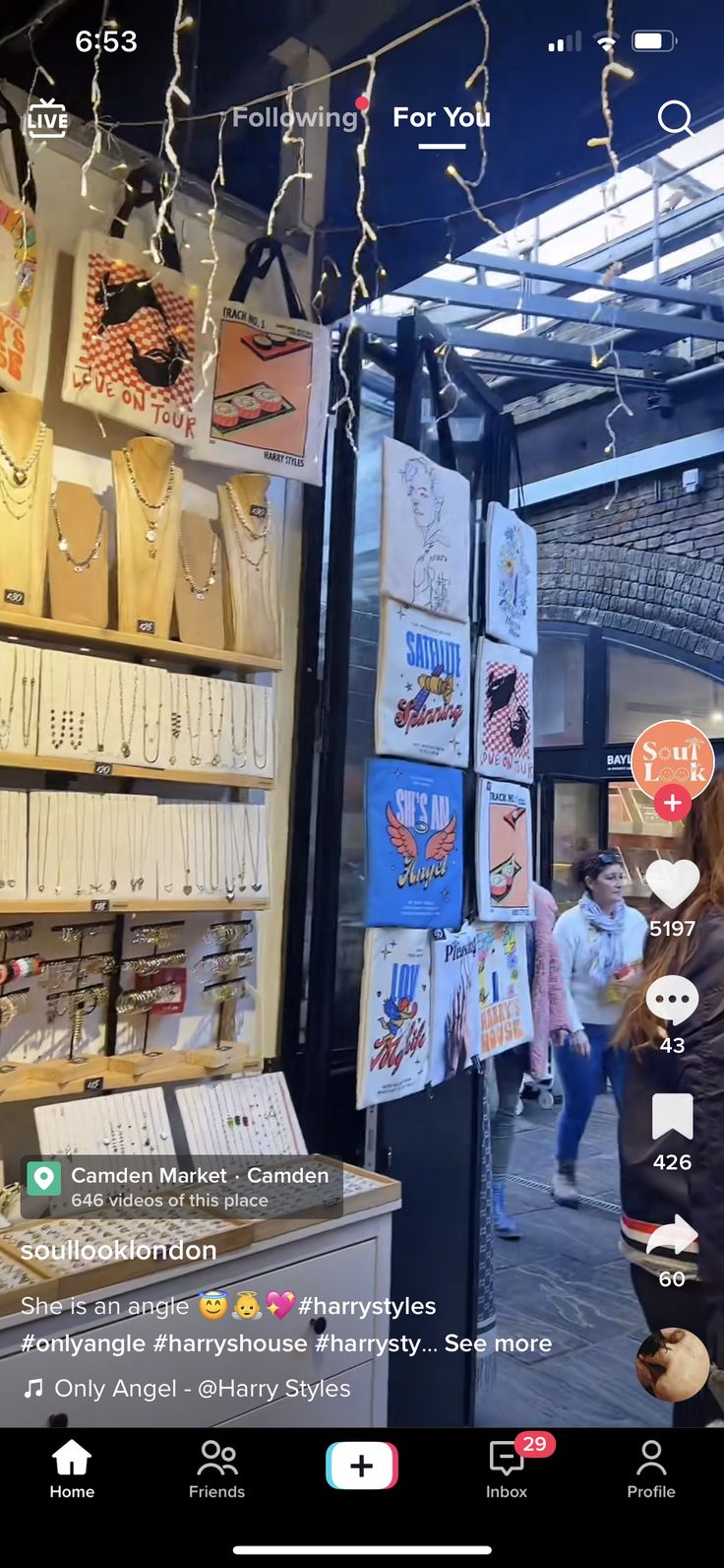 an image of the inside of a store with many items on display and people walking by