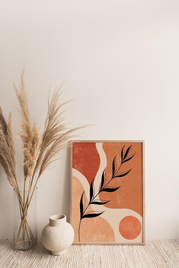 two vases are sitting next to a painting on a shelf in front of a white wall