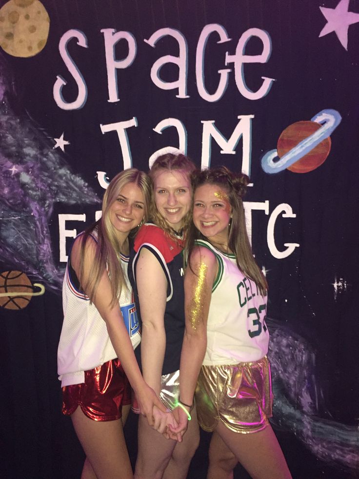 three girls posing in front of a space themed backdrop