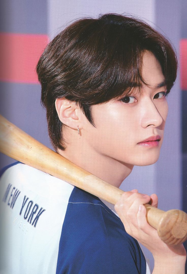 a young man holding a baseball bat in his hand