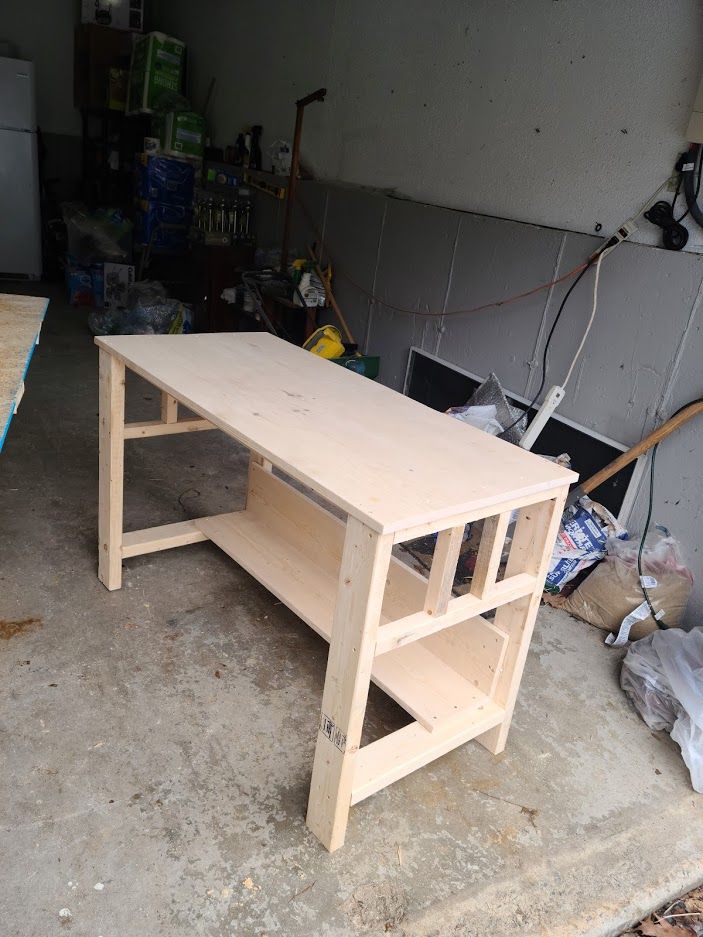 a wooden table sitting on top of a cement floor