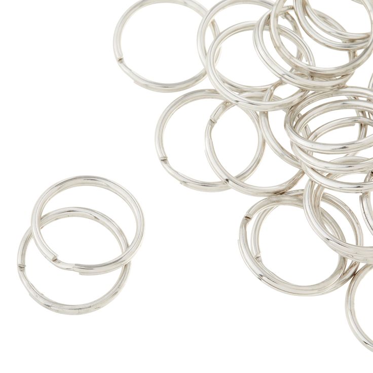 several silver colored rings on a white background