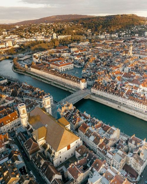 an aerial view of the city and river in europe, with buildings on both sides