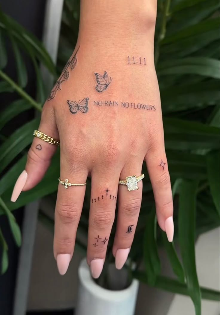 a woman's hand with tattoos on it