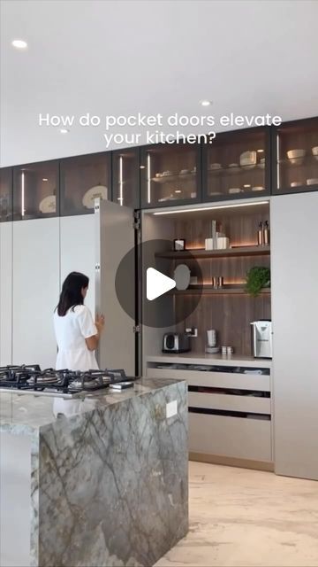 a woman standing in front of a stove top oven