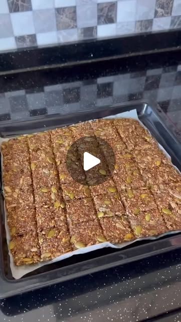 a pan filled with granola bars on top of a stove next to a frying pan