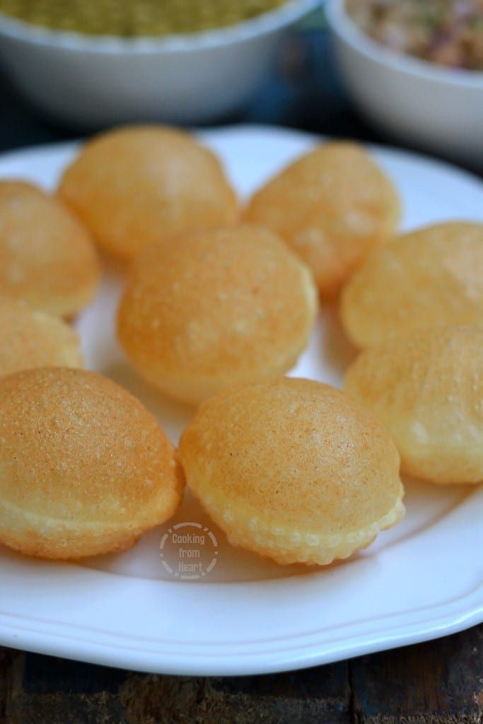 some food is on a white plate and ready to be eaten with other dishes in the background