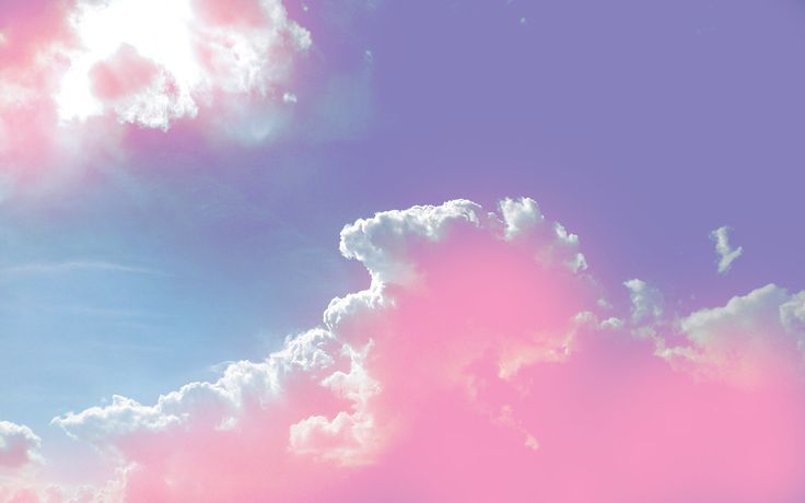 an airplane is flying in the sky with pink and blue clouds behind it on a sunny day