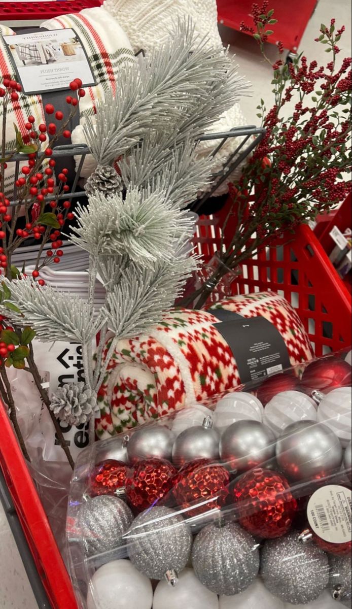 red and white christmas ornaments in a shopping cart