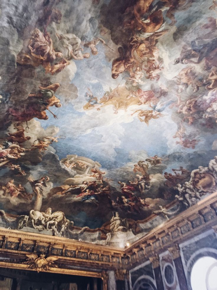 an ornate painting on the ceiling of a building