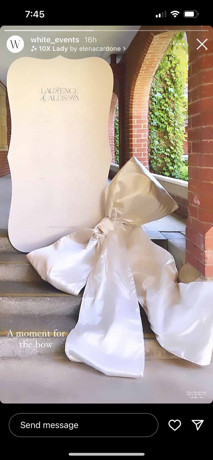 the wedding dress is laying on top of the stairs in front of an arch and brick building