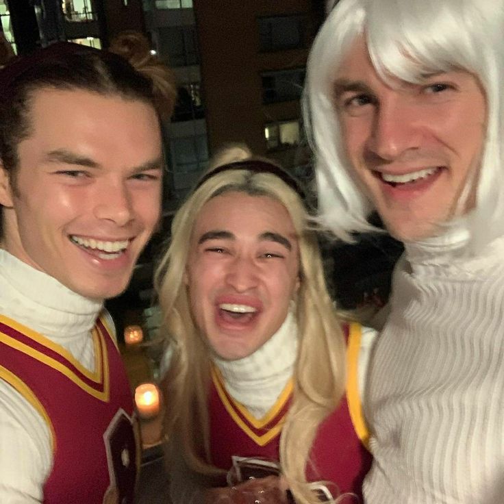 two men and a woman dressed up as cheerleaders