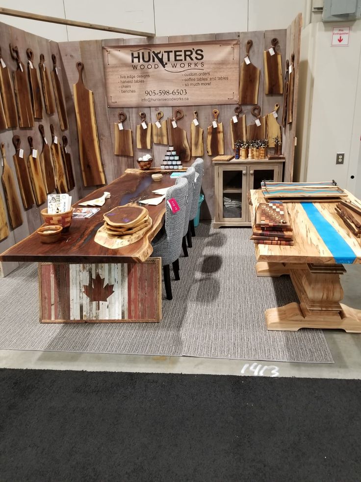 a table and chairs made out of wooden planks in a room with an advertisement on the wall