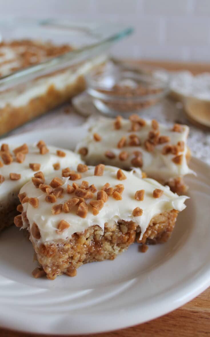 two pieces of cake on a plate with white frosting and sprinkles