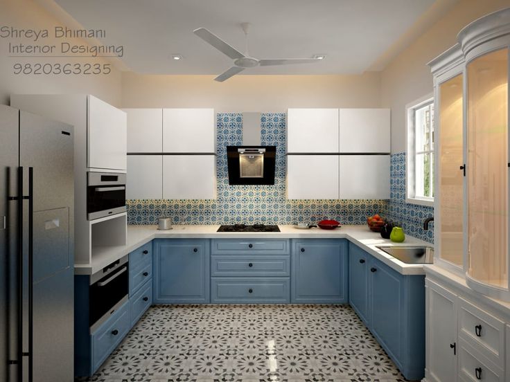 a kitchen with blue and white cabinets and floor tiles on the walls, along with a black stove top oven