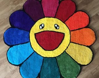 a colorful rug with a smiley face drawn on the front and sides, sitting on top of a hard wood floor