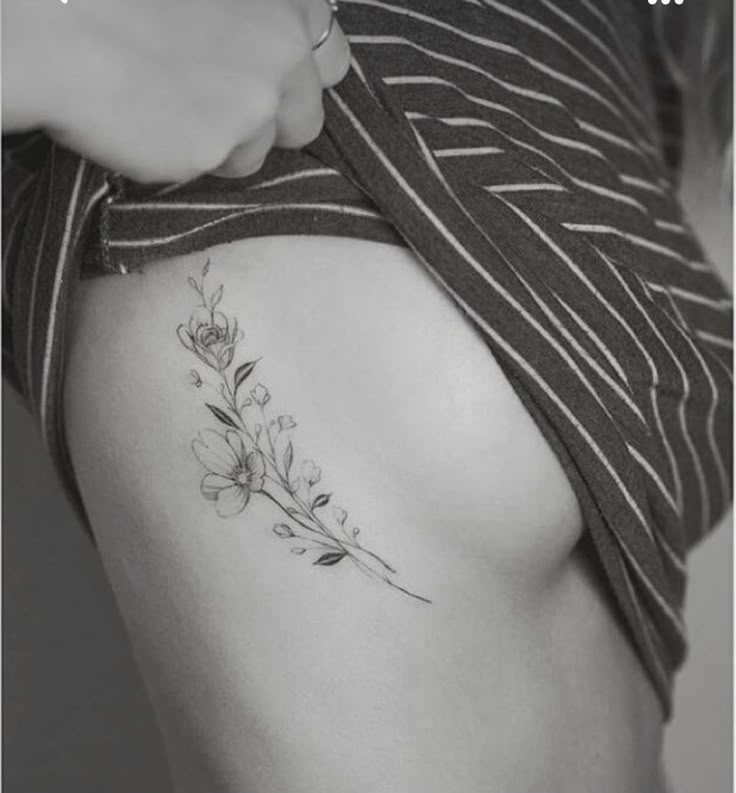 a woman with a flower tattoo on her stomach