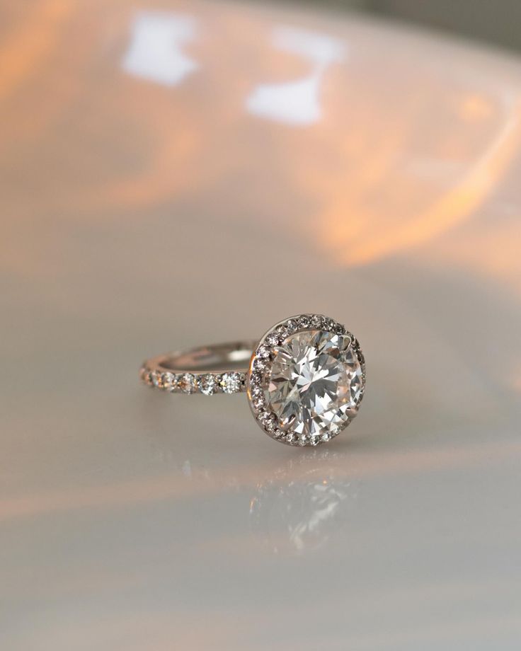 a diamond ring sitting on top of a white plate